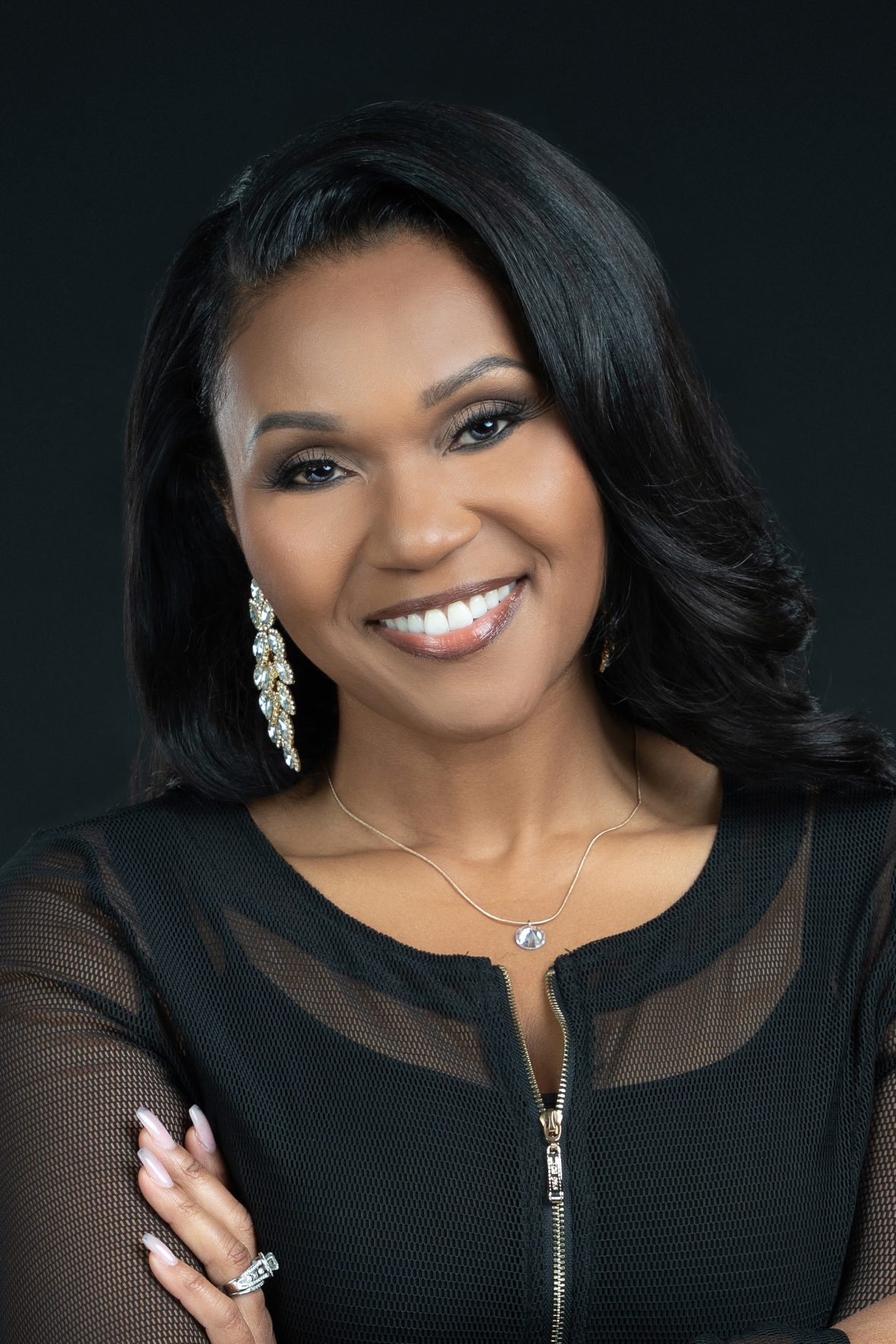 Headshot of Aundi in a black zipper cardigan