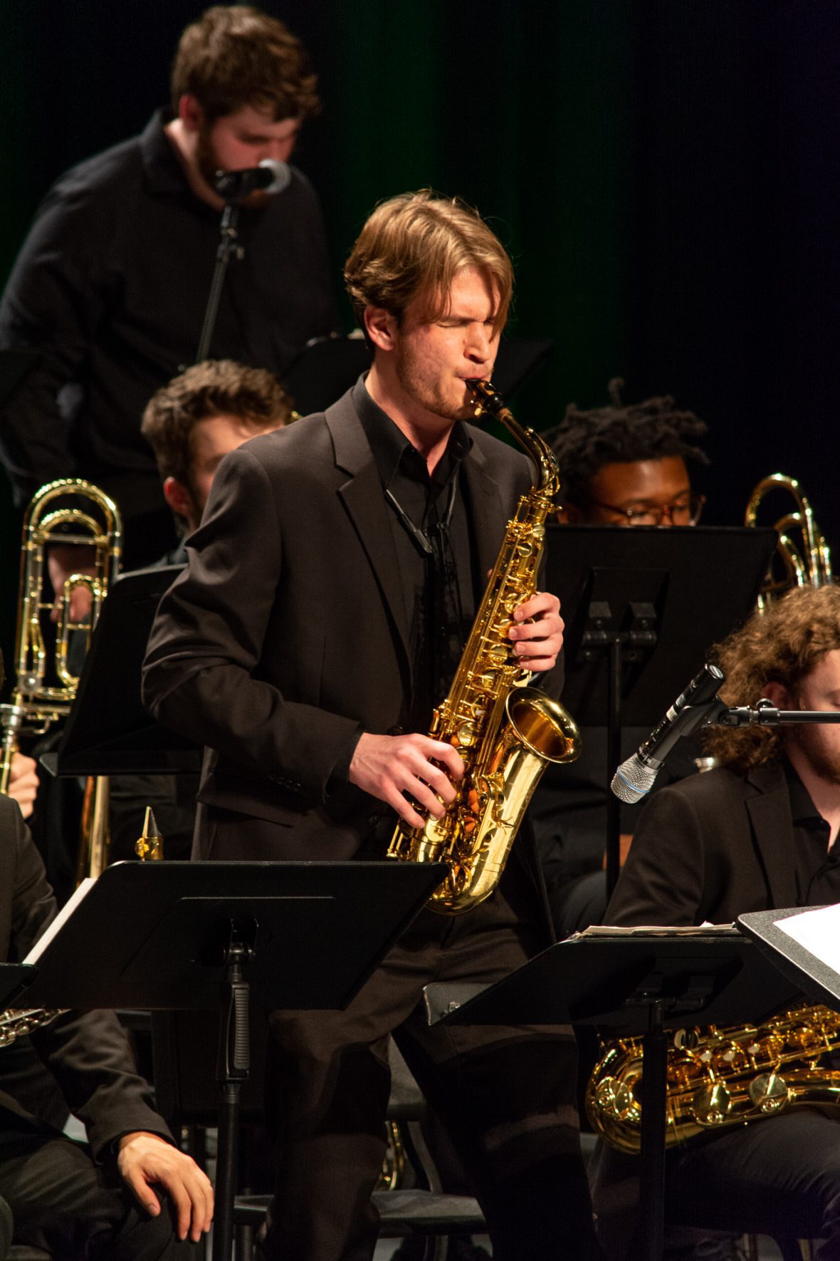 Adam on stage playing the saxophone