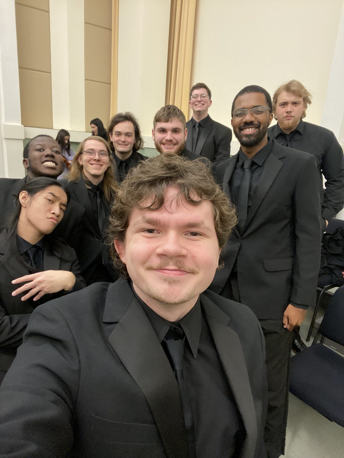 A selfie of student Jack Richardson in the choral room with fellow ensemble members