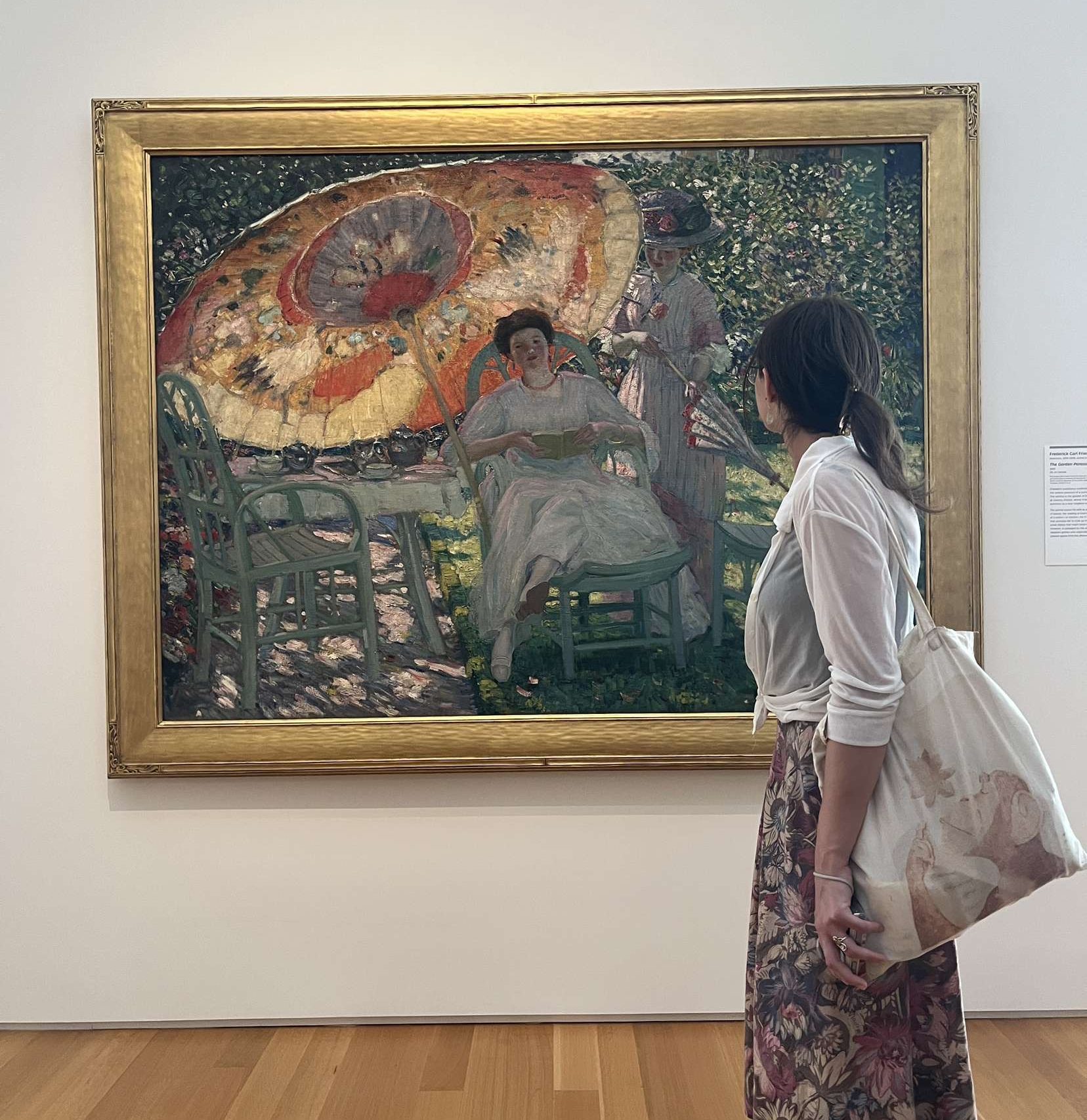 student looking at art in a museum