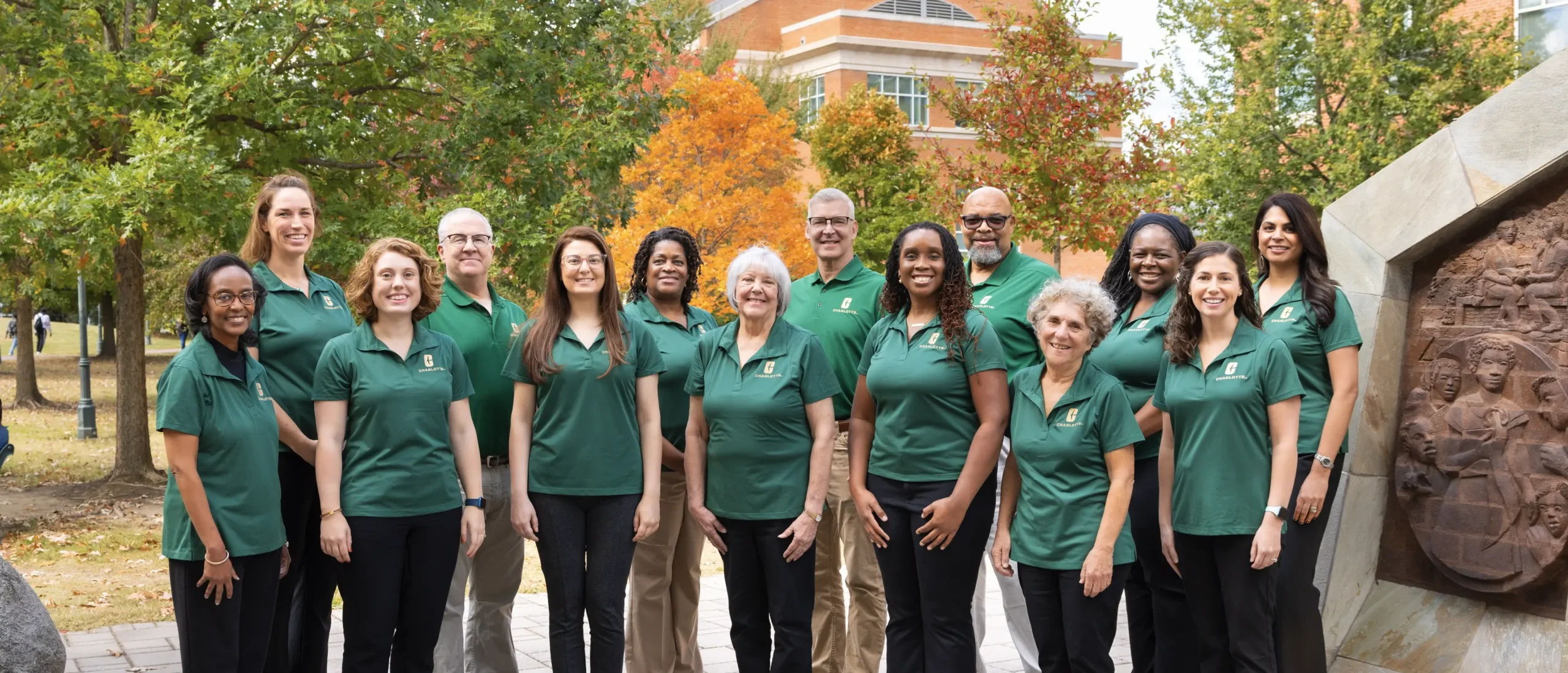 Group picture of people in green shirts outside